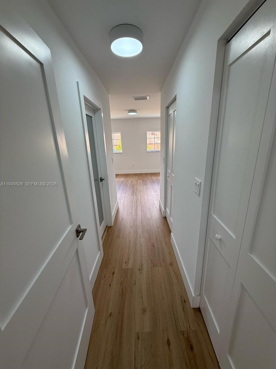 13911 Southwest 100th Lane Miami, FL 33186 - Photo 32 of 55 a view of a hallway with wooden floor and staircase