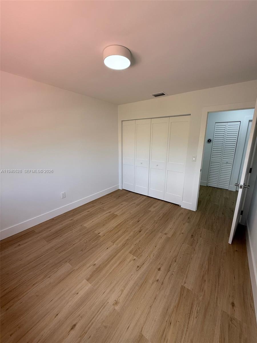 13911 Southwest 100th Lane Miami, FL 33186 - Photo 33 of 55 a view of empty room with wooden floor