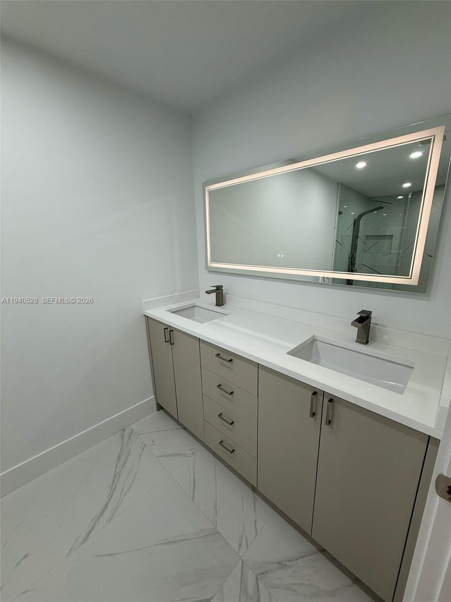 13911 Southwest 100th Lane Miami, FL 33186 - Photo 39 of 55 a spacious bathroom with a double vanity sink and mirror