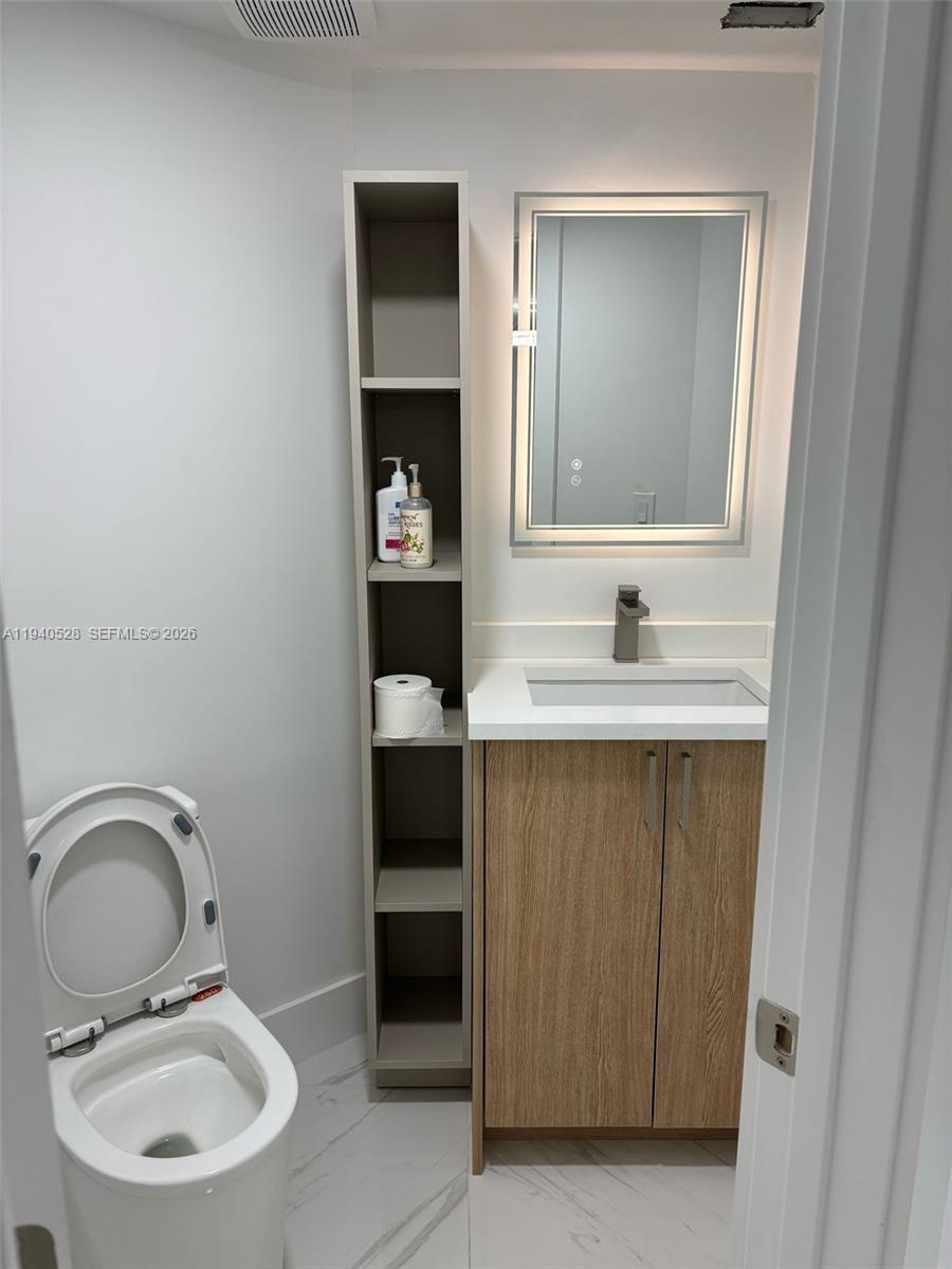 13911 Southwest 100th Lane Miami, FL 33186 - Photo 44 of 55 a bathroom with a sink and a mirror