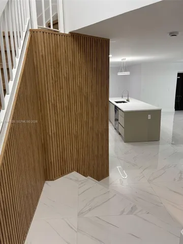 a room with a sink cabinets and window