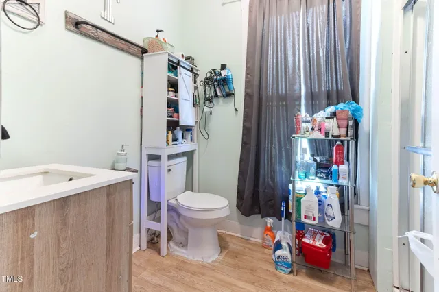 a bathroom with a sink toilet vanity and shower