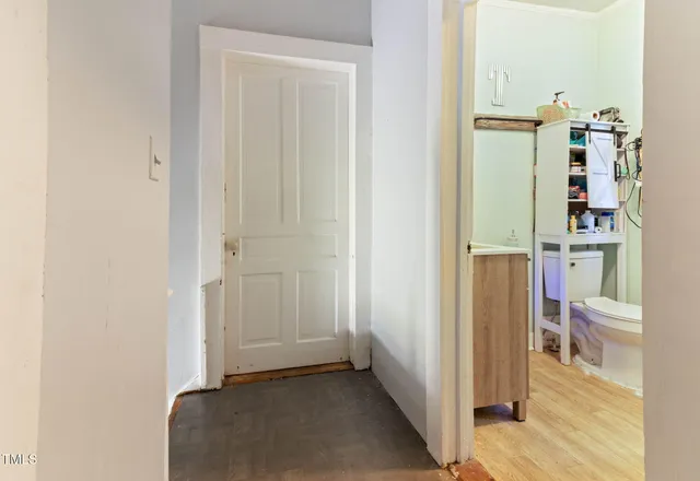 a view of an entryway with wooden floor and staircase