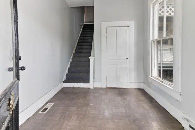 a dining room with furniture and wooden floor