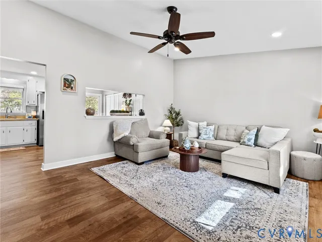 a living room with furniture and a wooden floor