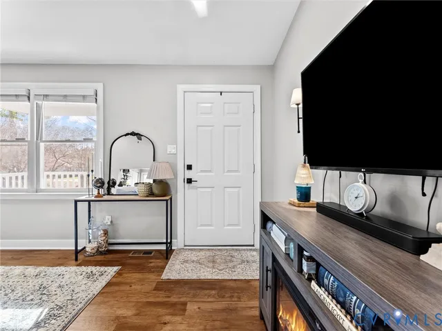 a view of living room filled with furniture and flat screen tv