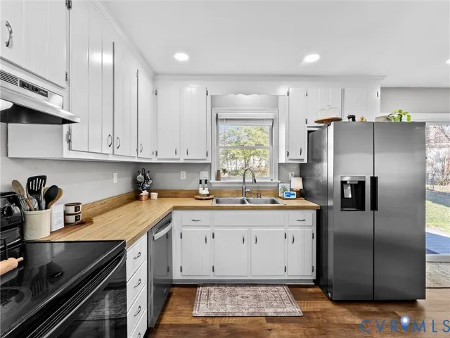a kitchen with a sink stainless steel appliances and cabinets