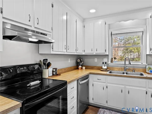 a kitchen with a sink appliances and cabinets