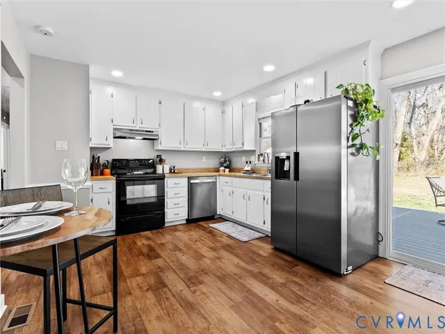 a kitchen with stainless steel appliances granite countertop a refrigerator sink and cabinets