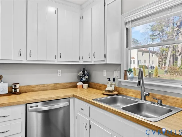 a kitchen with stainless steel appliances granite countertop a sink a stove and cabinets