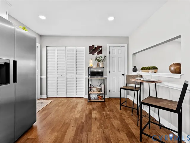 a view of a livingroom with furniture and a kitchen