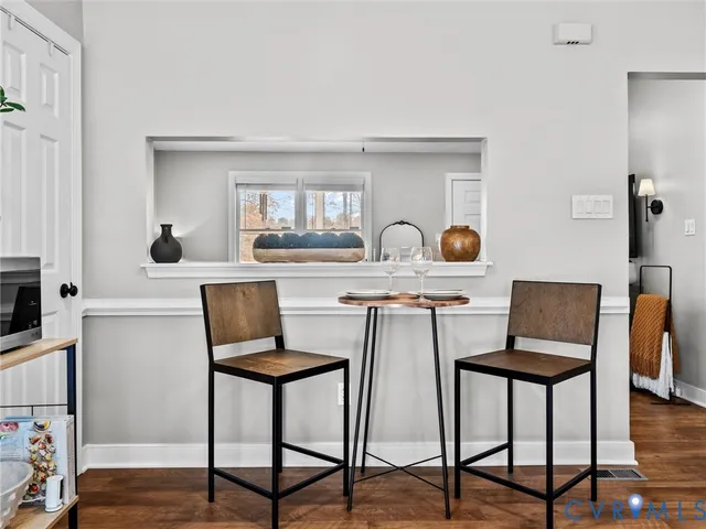 a kitchen with a table chairs and a refrigerator