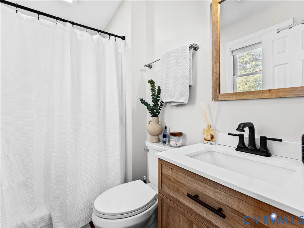 4507 Parrish Branch Road Midlothian, VA 23112 - Photo 30 of 40 a bathroom with a sink a toilet and a mirror