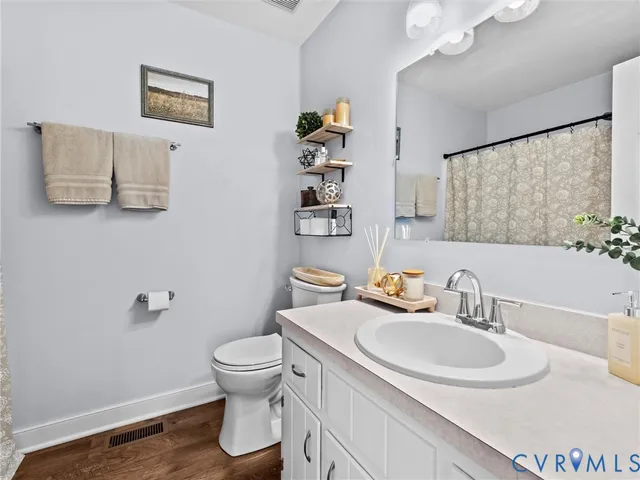 a bathroom with a sink toilet and a mirror