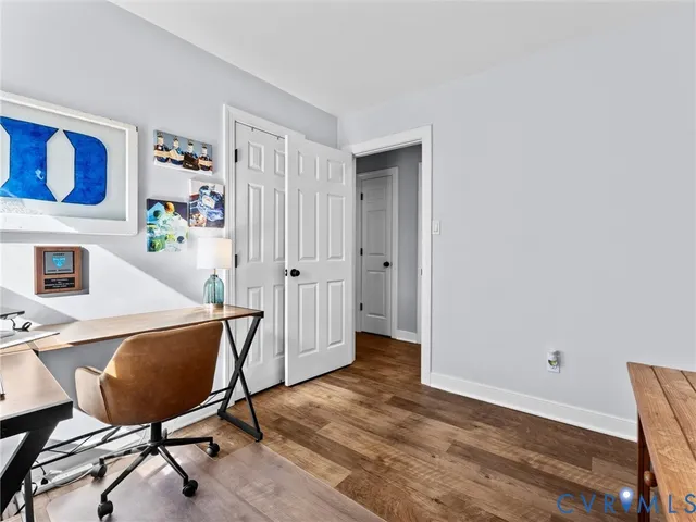 a view of a workspace with furniture and wooden floor