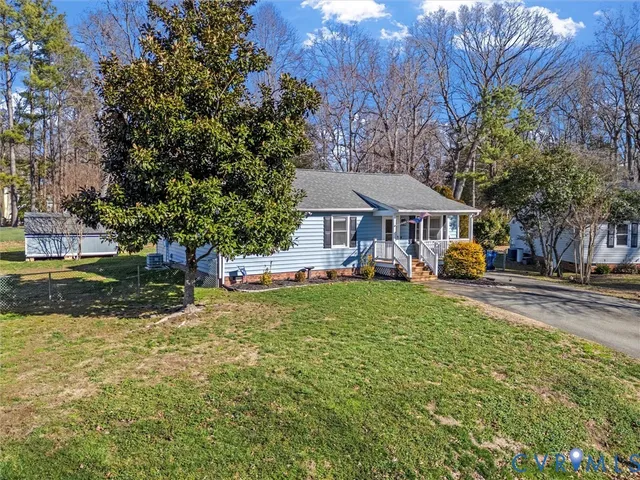 a front view of a house with a yard table and chairs