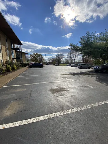 a view of a car park in front of house