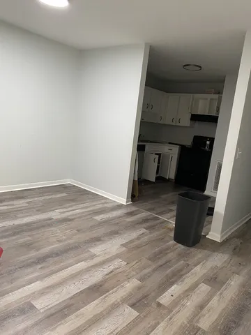 a view of an empty room and wooden floor
