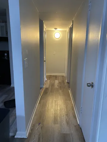 a view of hallway with wooden floor