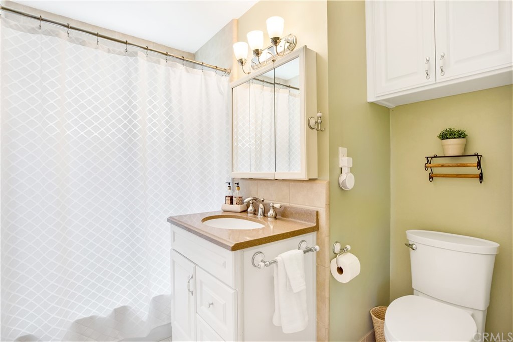844 Eastman Place San Pedro, CA 90731 - Photo 31 of 44 a bathroom with a granite countertop sink and a mirror