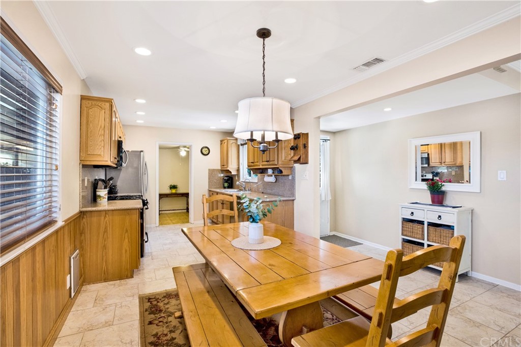 844 Eastman Place San Pedro, CA 90731 - Photo 6 of 44 a view of a dining room and livingroom with furniture wooden floor a rug a fireplace and a chandelier