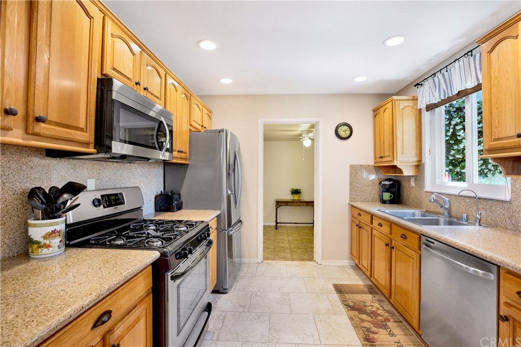 844 Eastman Place San Pedro, CA 90731 - Photo 7 of 44 a kitchen with stainless steel appliances granite countertop a stove a sink and a refrigerator