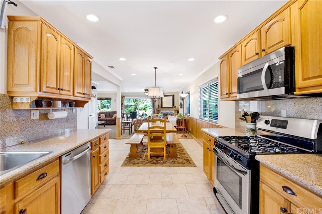 844 Eastman Place San Pedro, CA 90731 - Photo 9 of 44 a kitchen with stainless steel appliances granite countertop a stove a sink and a microwave