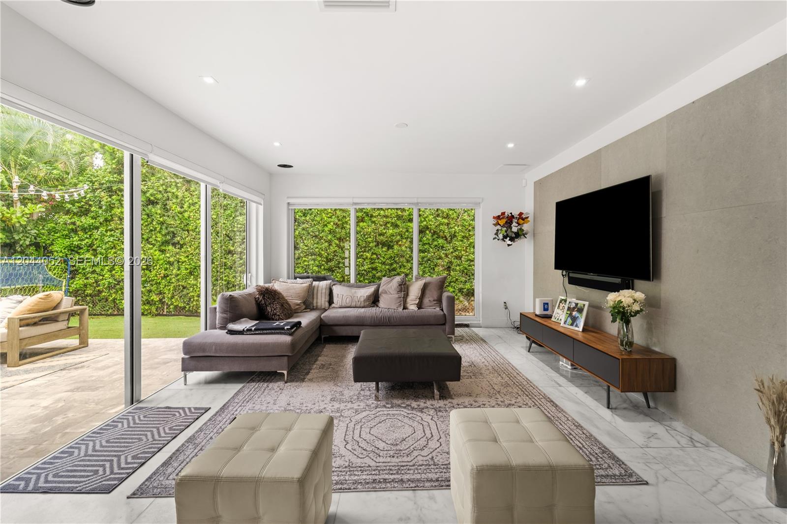 721 Bird Road Coral Gables, FL 33146 - Photo 4 of 24 a living room with furniture and a flat screen tv