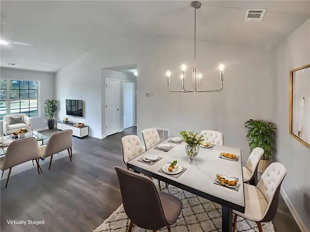 a view of a dining room furniture and wooden floor