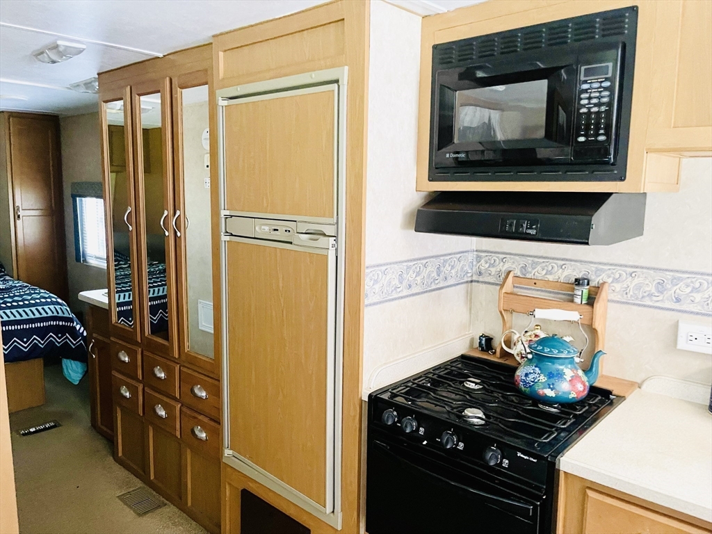 67 Crane Road Chester, MA 01011 - Photo 18 of 21 a kitchen with a stove and a refrigerator