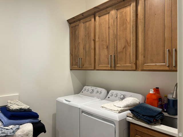 2688 Read Lane Preston, ID 83263 - Photo 9 of 18 Laundry area featuring built-in wood cabinetry with brushed nickel hardware, a countertop sink, and light-toned walls