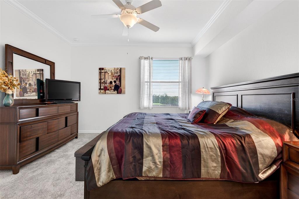16904 Vardon Terrace, Unit 301 Lakewood Ranch, FL 34211 - Photo 16 of 53 a bedroom with a bed and a flat screen tv