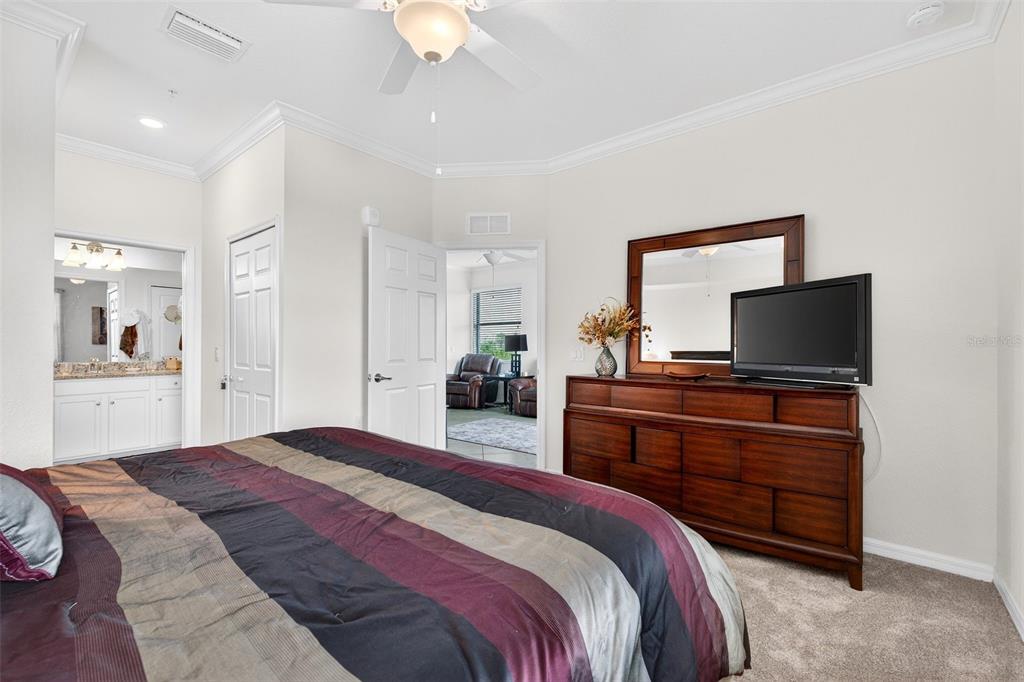 16904 Vardon Terrace, Unit 301 Lakewood Ranch, FL 34211 - Photo 17 of 53 a bedroom with a bed and a flat screen tv