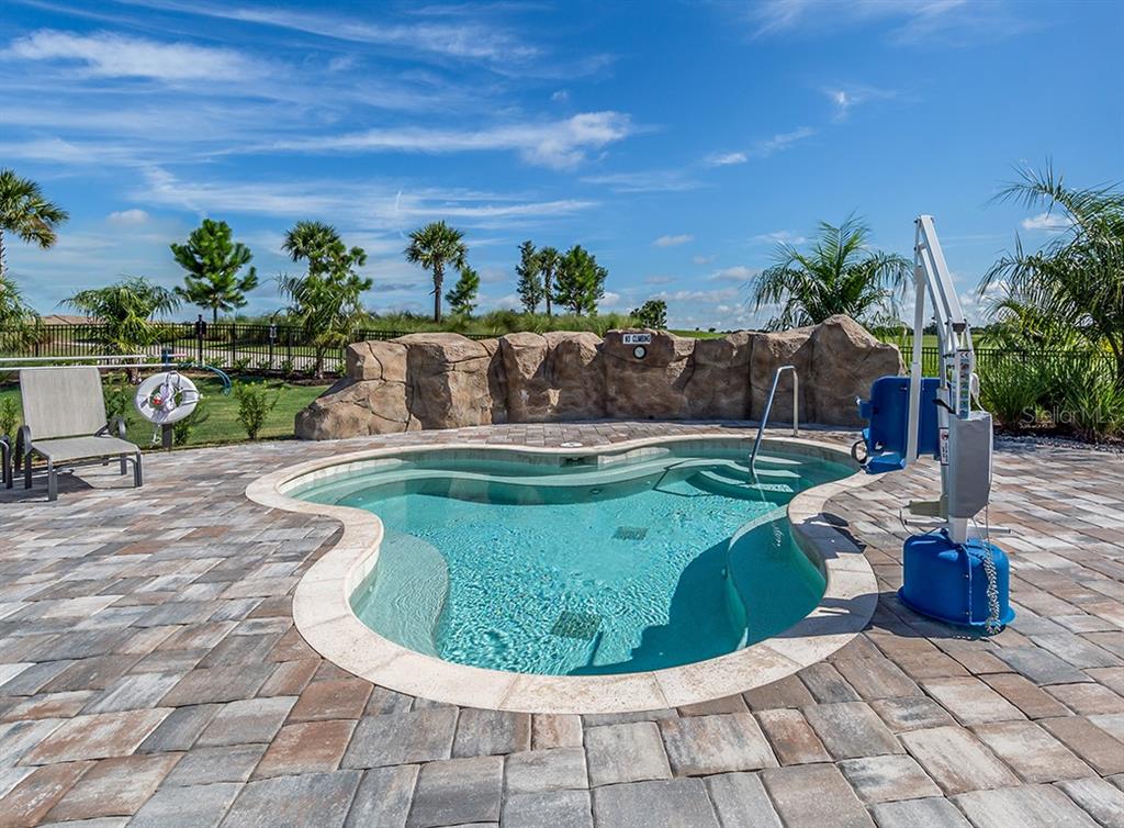 16904 Vardon Terrace, Unit 301 Lakewood Ranch, FL 34211 - Photo 39 of 53 a view of a swimming pool with a yard