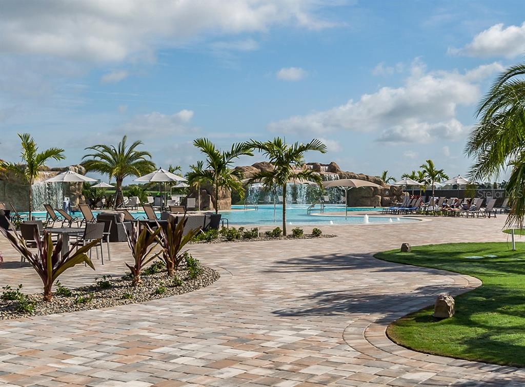 16904 Vardon Terrace, Unit 301 Lakewood Ranch, FL 34211 - Photo 40 of 53 a view of a backyard with a table and chairs