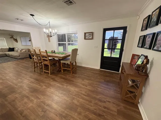 a view of a dining room with furniture and window