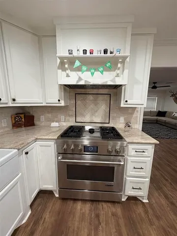 a stove top oven sitting inside of a kitchen
