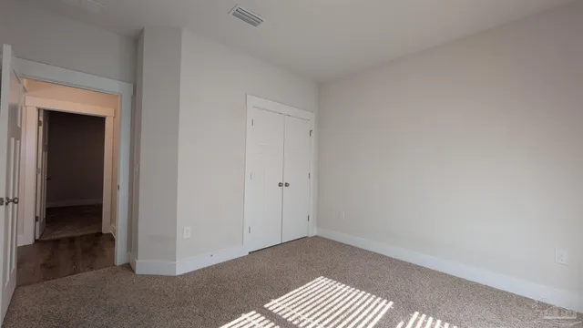 a view of an empty room and closet