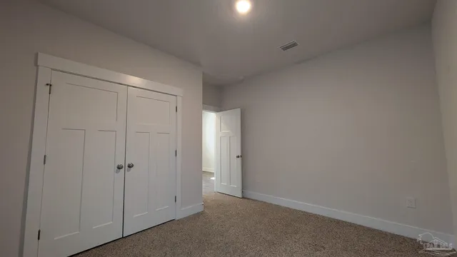 an empty room with closet area