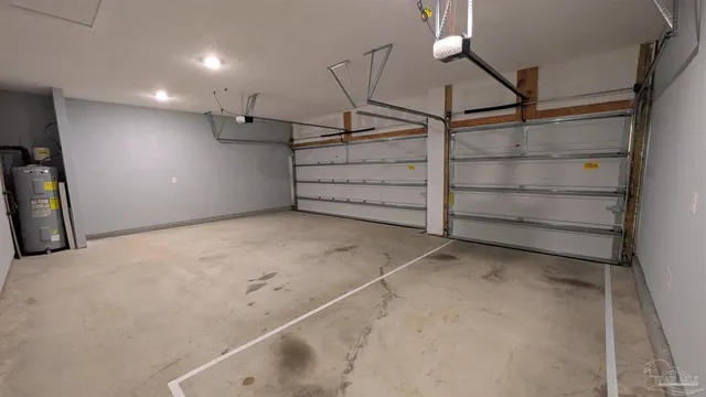 a view of a small space with plants and wooden fence