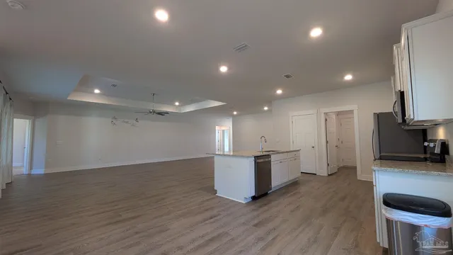 a view of a kitchen with a sink and a refrigerator