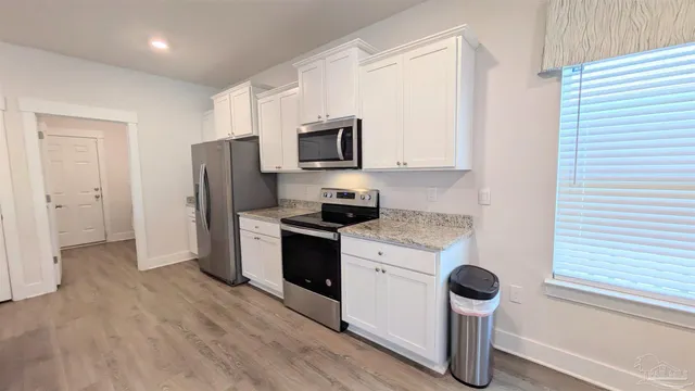 a kitchen with a refrigerator and a sink
