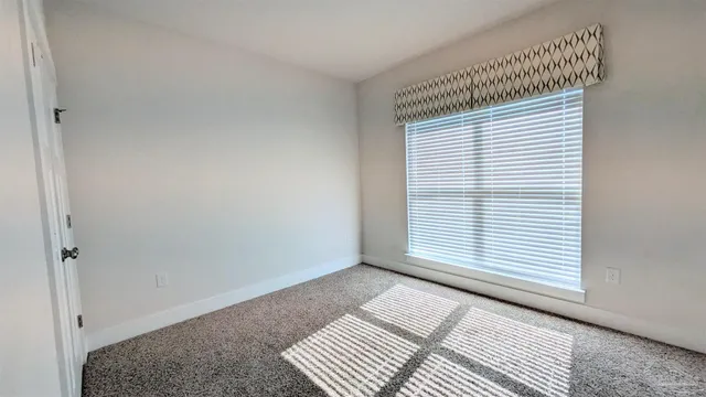 a view of wooden floor and windows in a room