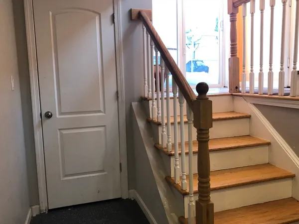 a view of entryway with wooden floor and stairs