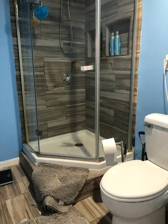 a bathroom with a toilet and shower
