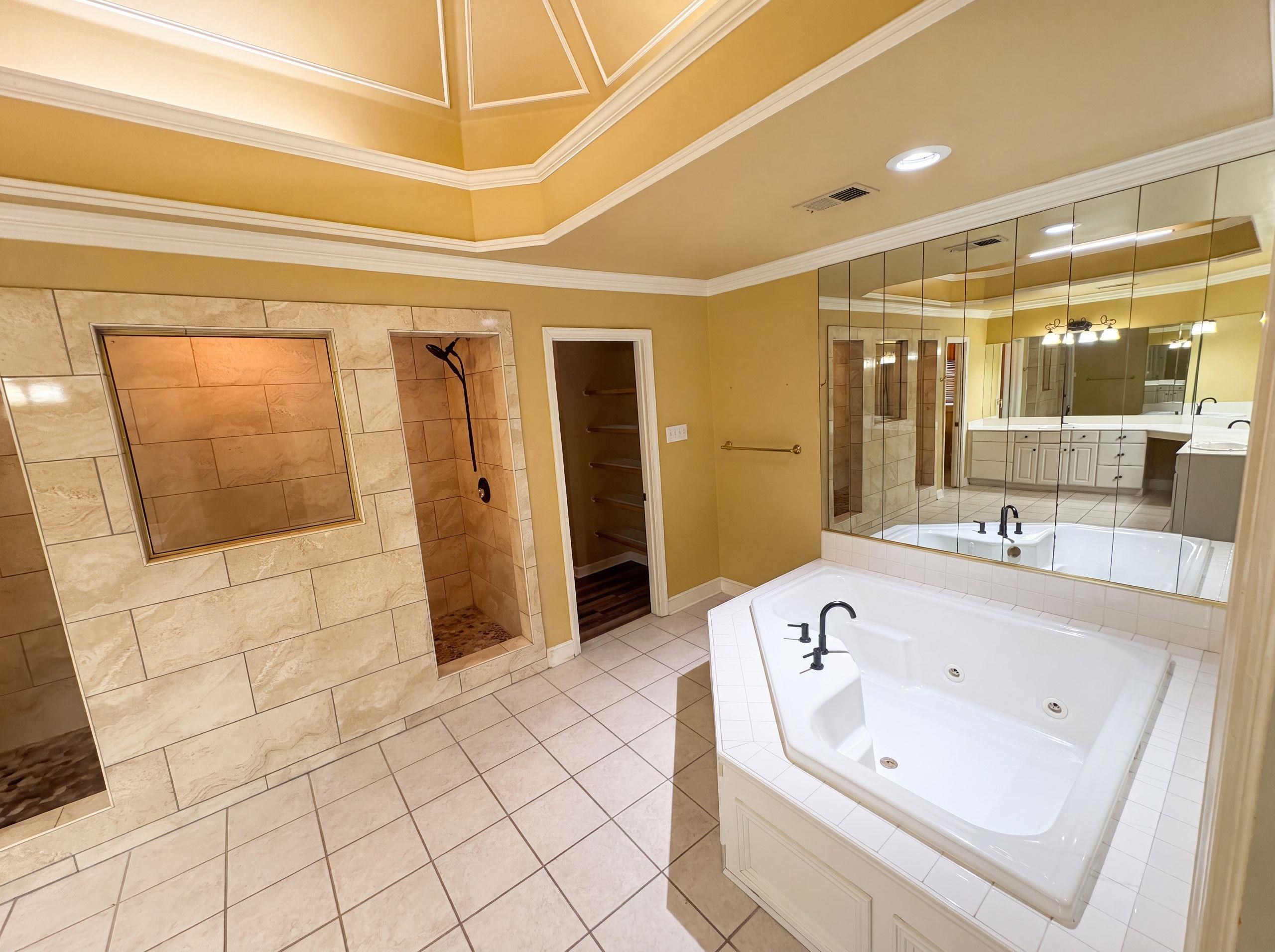 9424 Gotten Road Germantown, TN 38139 - Photo 22 of 27 Tile flooring encompassing a corner soaking tub and dual walk-in showers