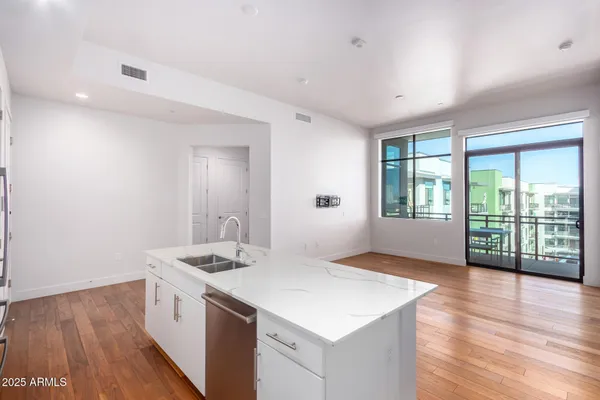 a kitchen with kitchen island a counter top space a sink appliances and cabinets