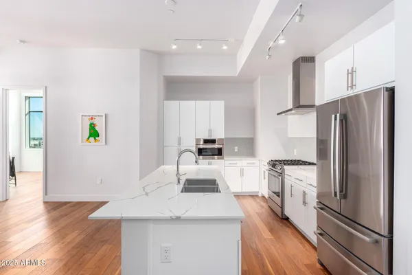 a kitchen with granite countertop a table chairs stove and cabinets
