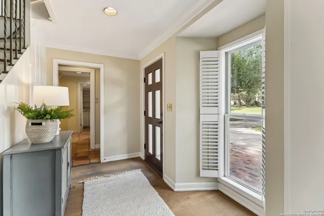 a living room with furniture a rug and a chandelier
