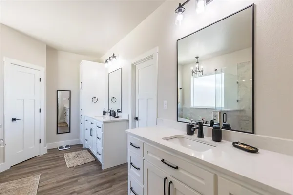 a en suite bathroom with double vanity and mirrors